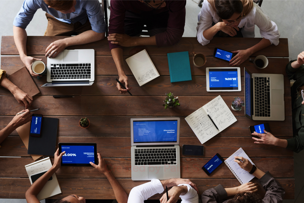 top view-photo-of-people-near-wooden-table-3183150
